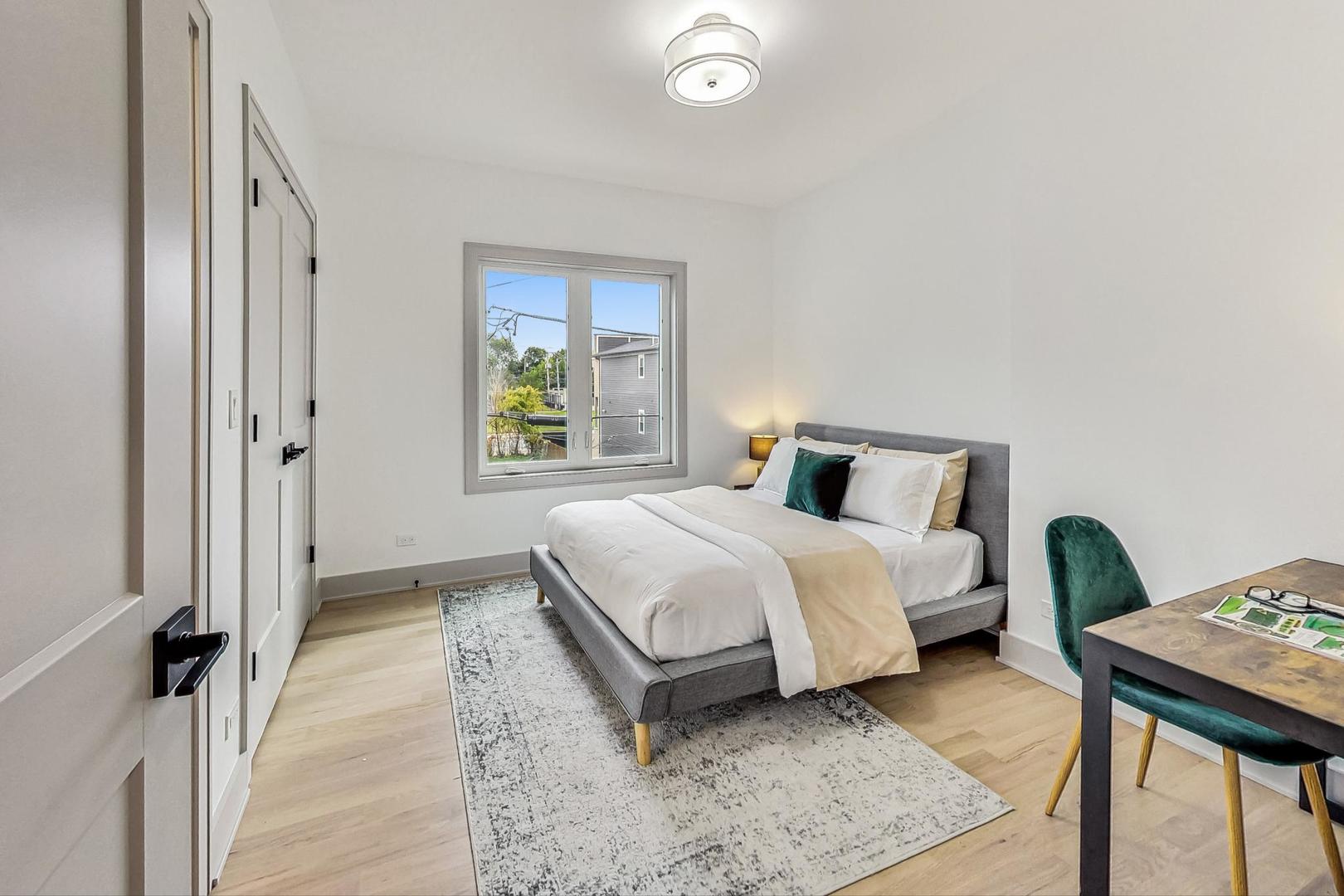 4244 South Champlain Avenue Chicago, IL 60653 - Photo 18 of 34 a bedroom with a bed and wooden floor