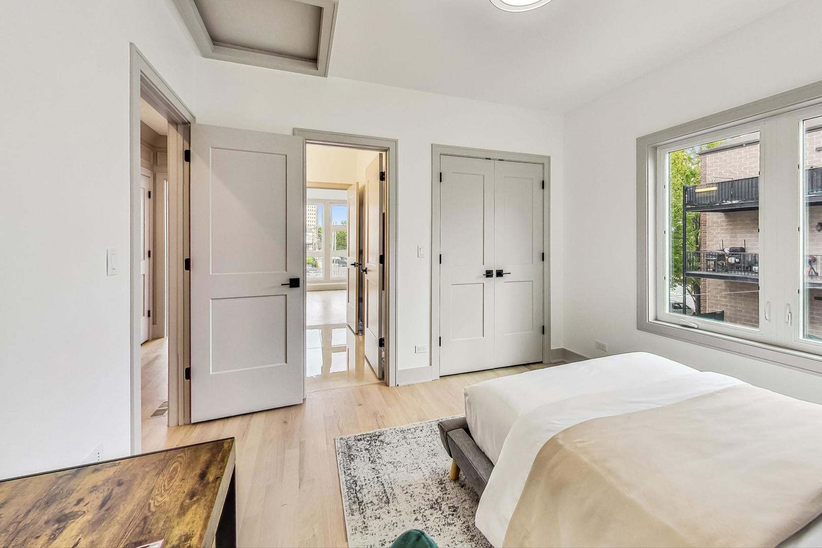 4244 South Champlain Avenue Chicago, IL 60653 - Photo 19 of 34 a bedroom with a bed and a mirror