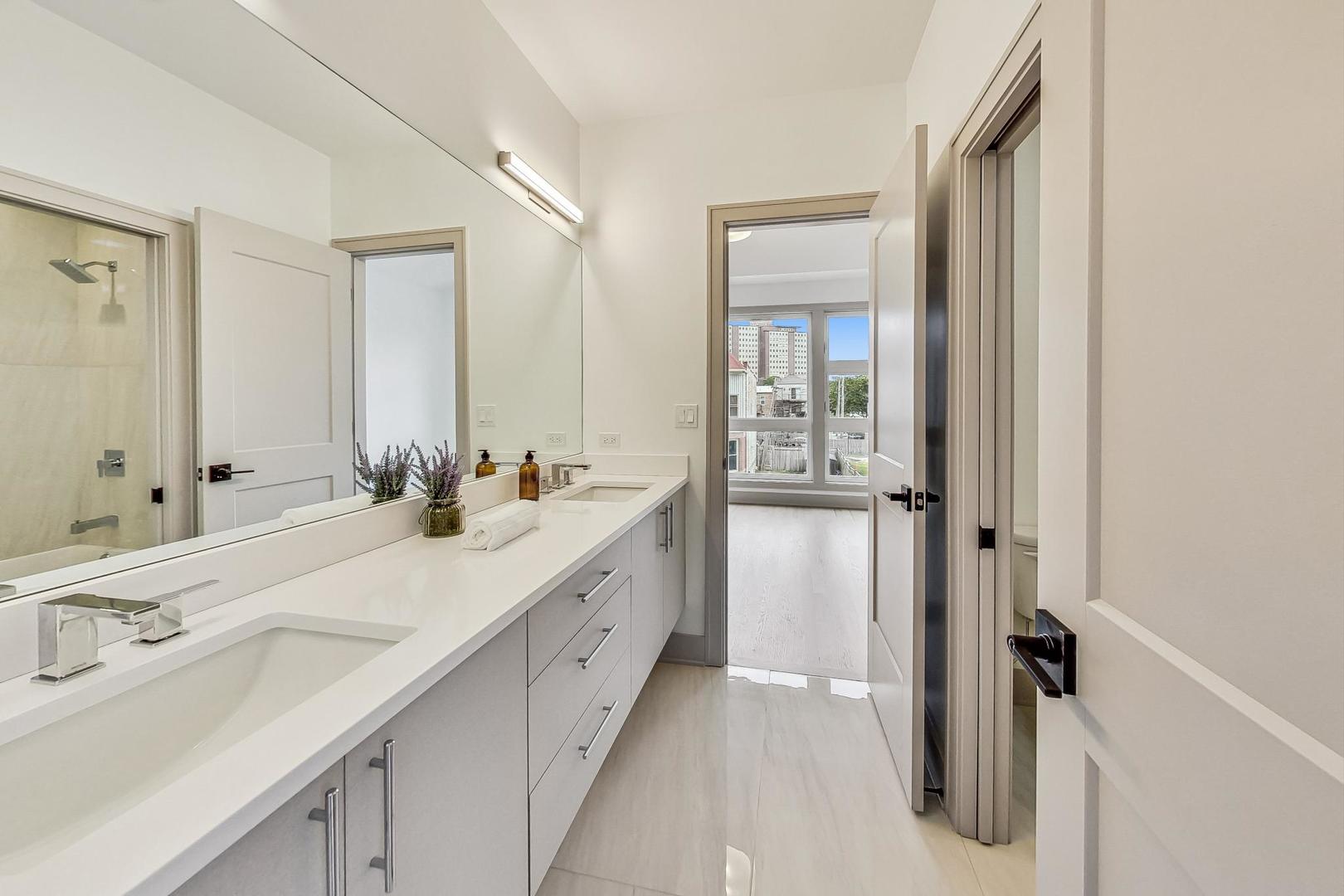 4244 South Champlain Avenue Chicago, IL 60653 - Photo 20 of 34 a bathroom with a double vanity sink mirror and double