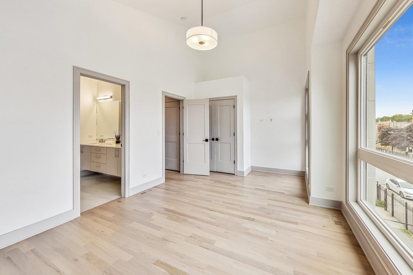 4244 South Champlain Avenue Chicago, IL 60653 - Photo 22 of 34 a view of a room with an entryway and wooden floor