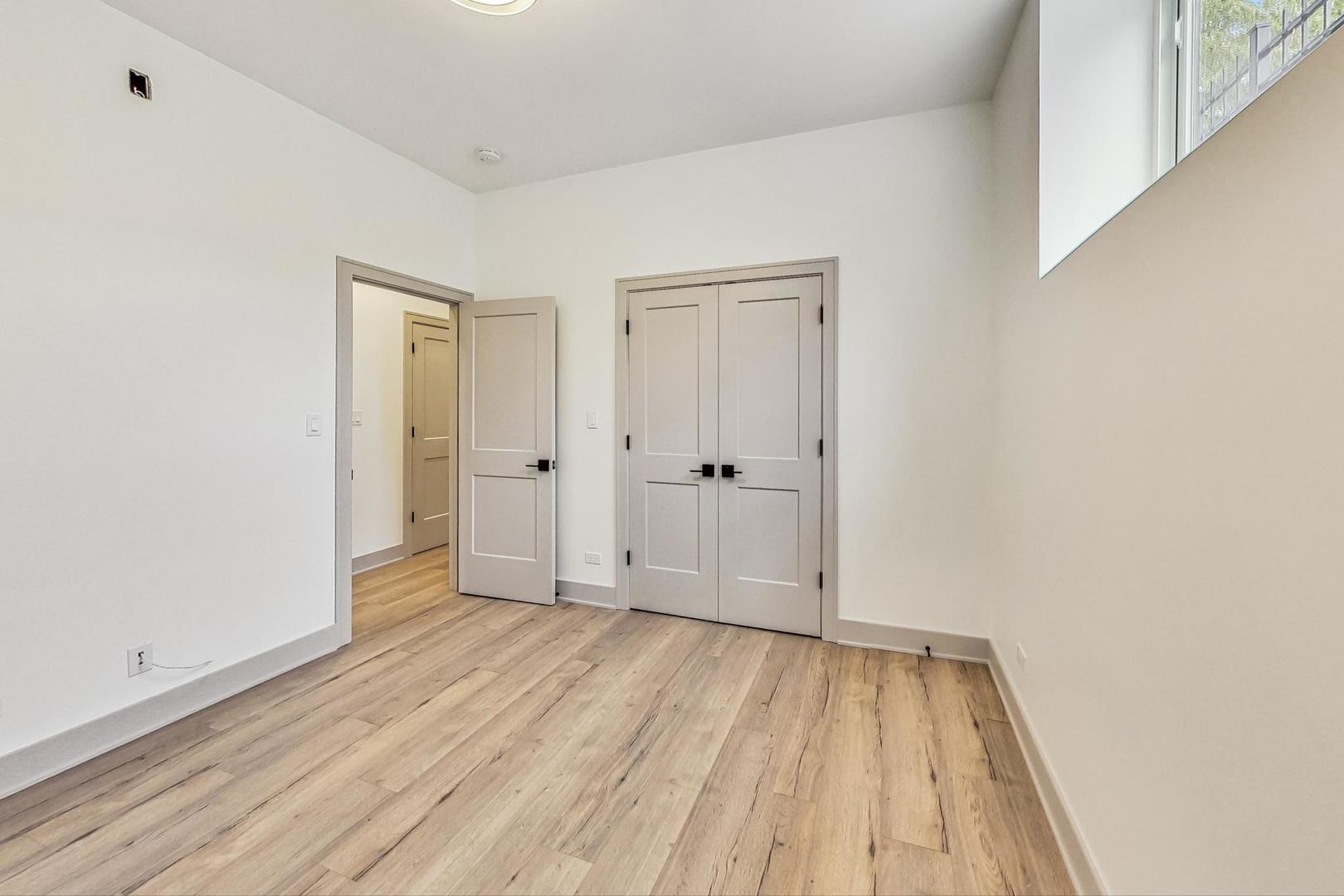 4244 South Champlain Avenue Chicago, IL 60653 - Photo 27 of 34 a view of an empty room with wooden floor