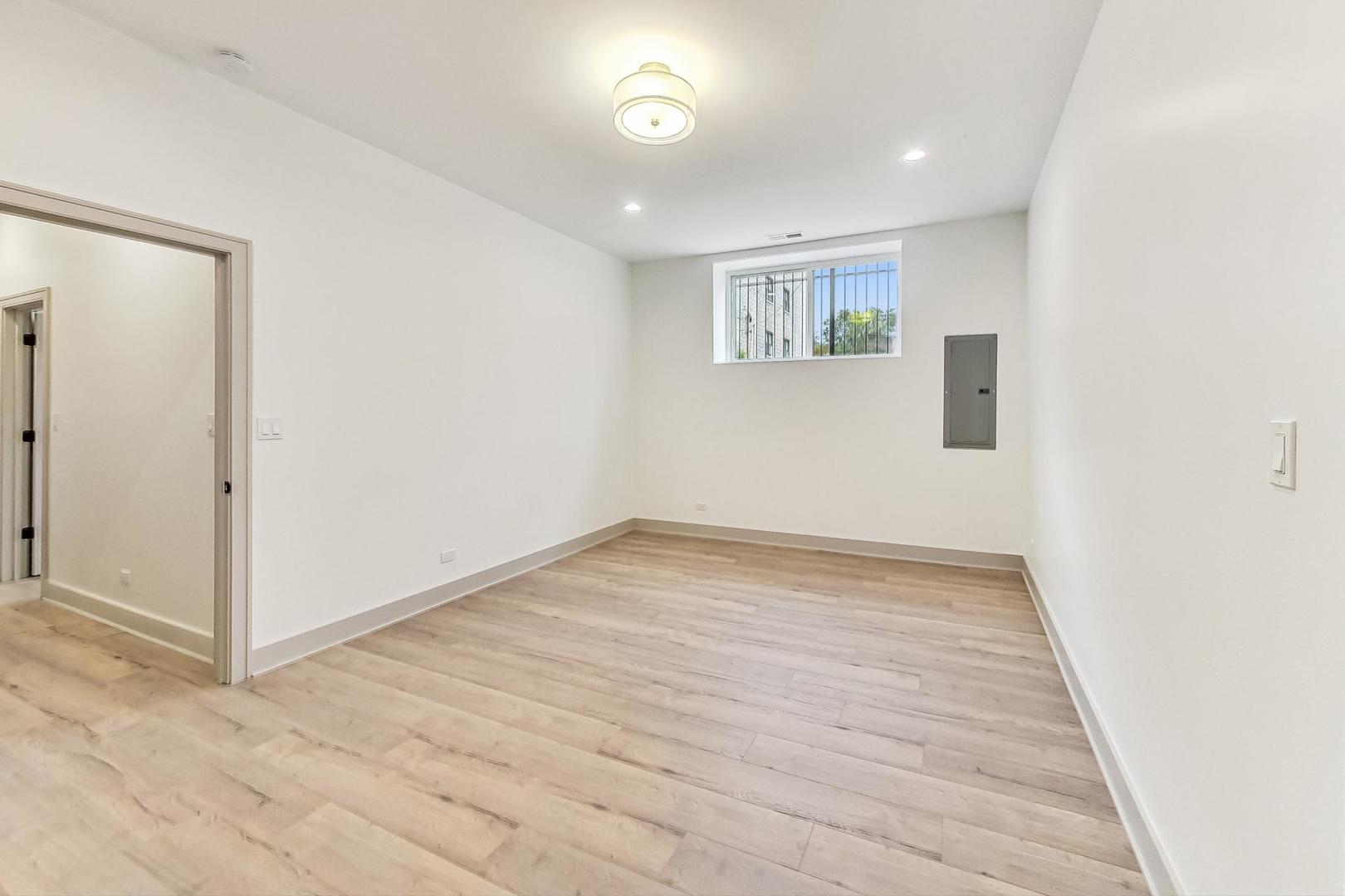 4244 South Champlain Avenue Chicago, IL 60653 - Photo 28 of 34 an empty room with wooden floor and windows