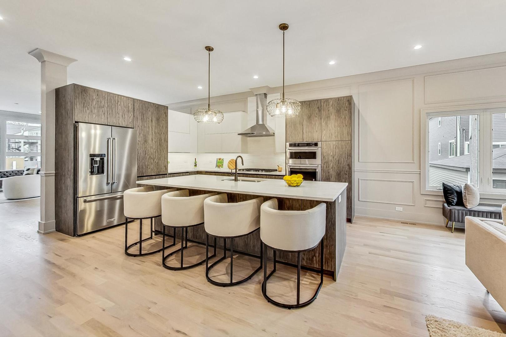 4244 South Champlain Avenue Chicago, IL 60653 - Photo 6 of 34 a large kitchen with a table and chairs