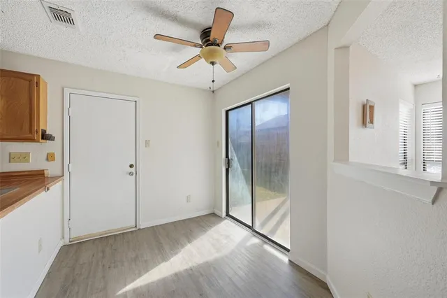 a view of a livingroom with a ceiling fan and window