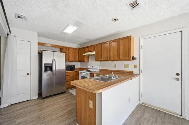 a kitchen that has a sink cabinets counter space and stainless steel appliances