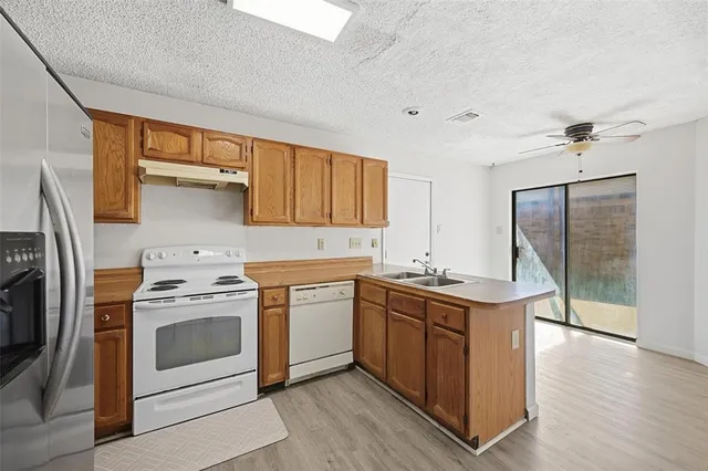 a kitchen with a stove top oven sink and cabinets