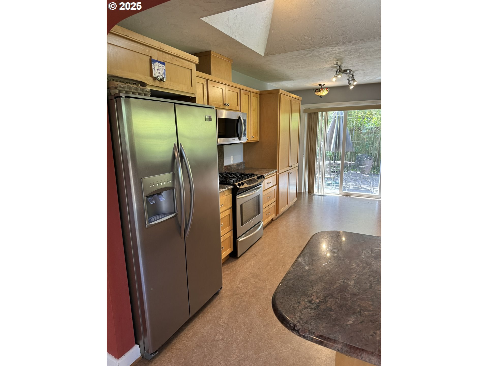 810 East 20th Avenue Eugene, OR 97405 - Photo 11 of 30 a kitchen with stainless steel appliances granite countertop a refrigerator and a sink