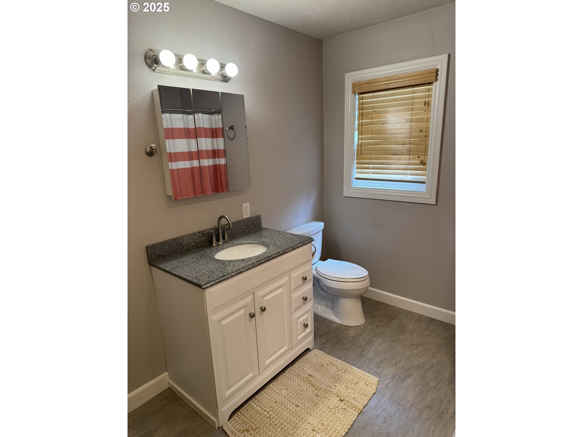 810 East 20th Avenue Eugene, OR 97405 - Photo 24 of 30 a spacious bathroom with a toilet sink and mirror
