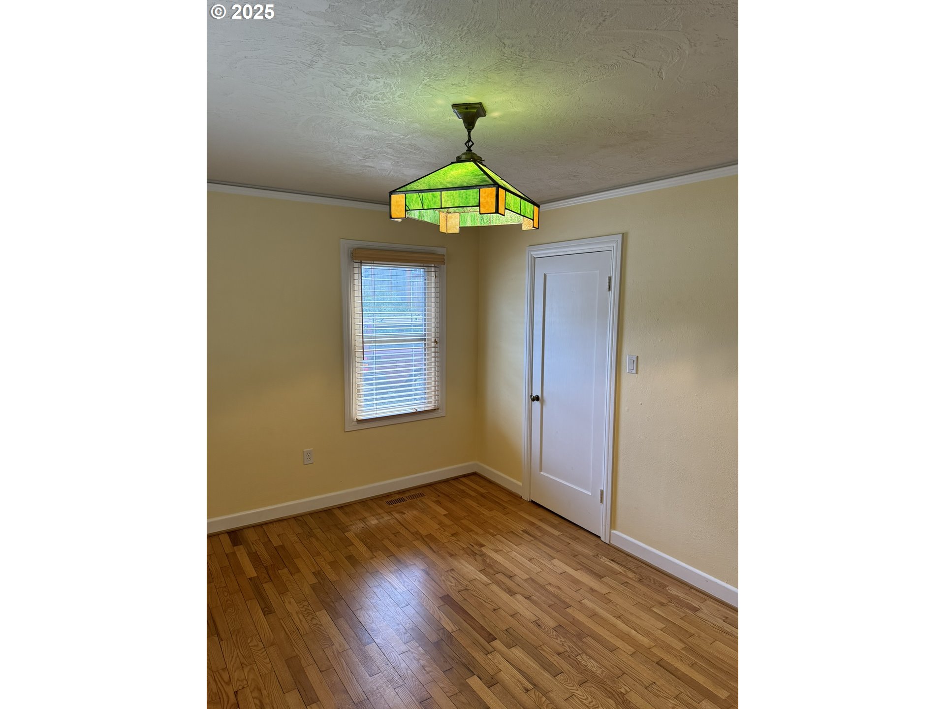 810 East 20th Avenue Eugene, OR 97405 - Photo 26 of 30 a view of a hallway with a chandelier and wooden floor