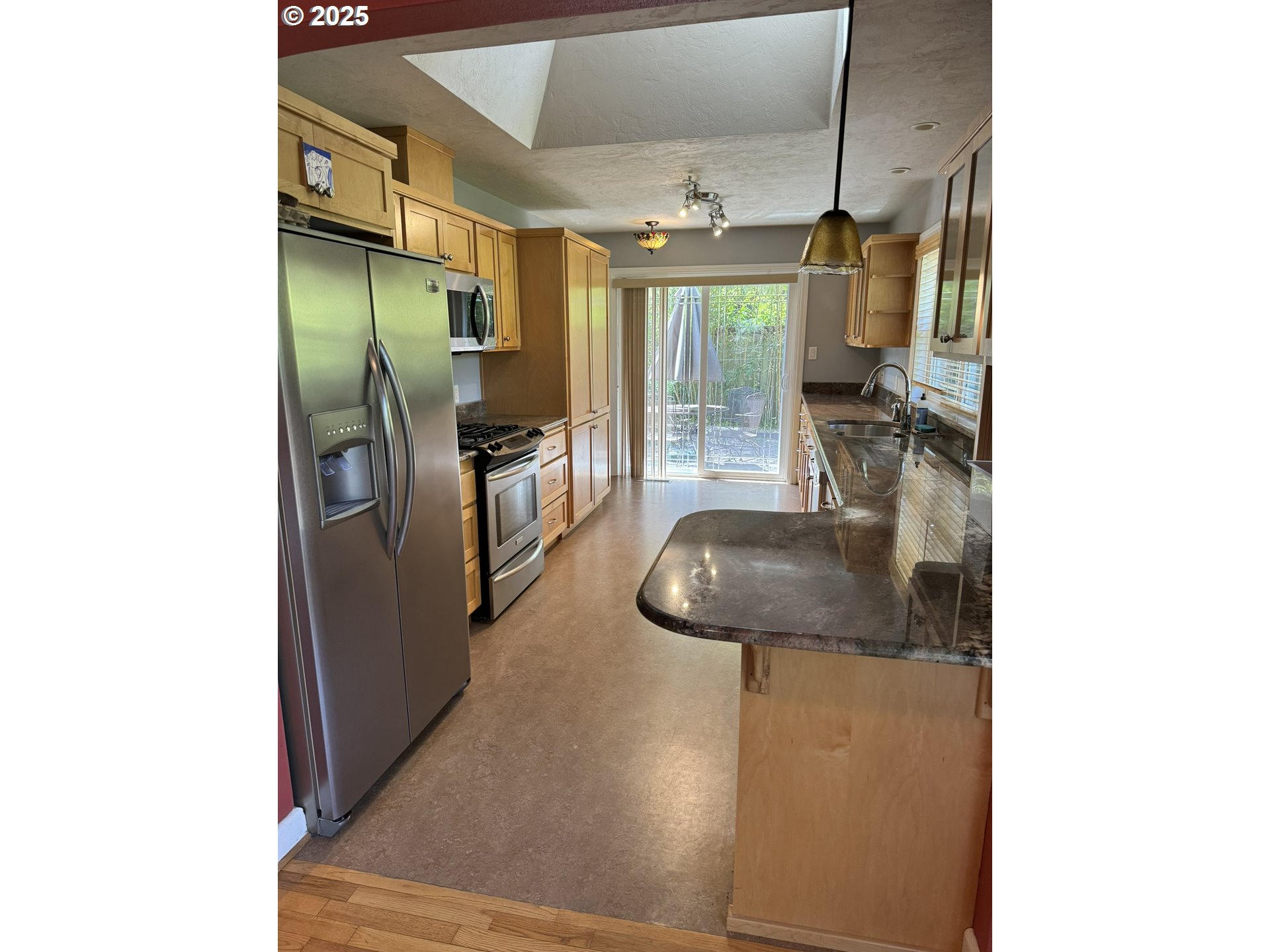 810 East 20th Avenue Eugene, OR 97405 - Photo 9 of 30 a view of a living room with furniture and a flat screen tv