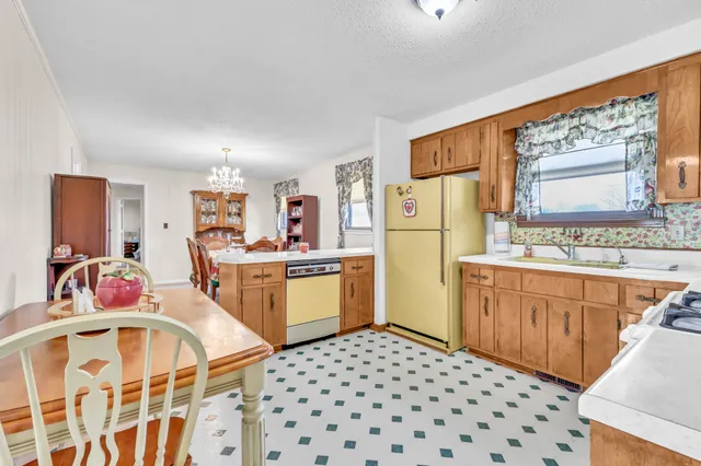 a kitchen with a refrigerator stove and sink