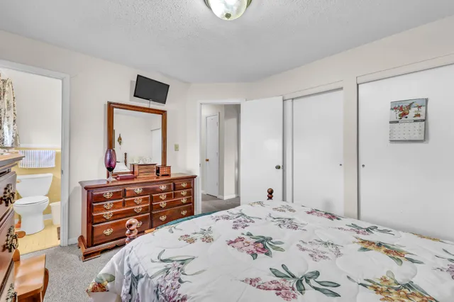 a bedroom with a bed and a dresser in it