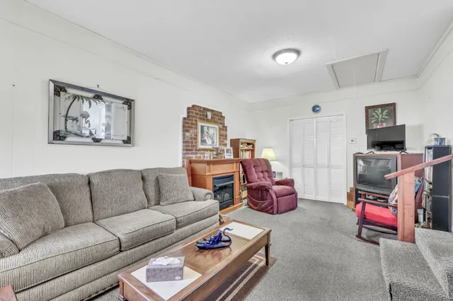 a living room with furniture flat screen tv and dresser
