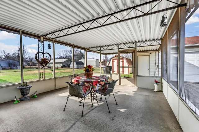 a view of a patio with a table and chairs