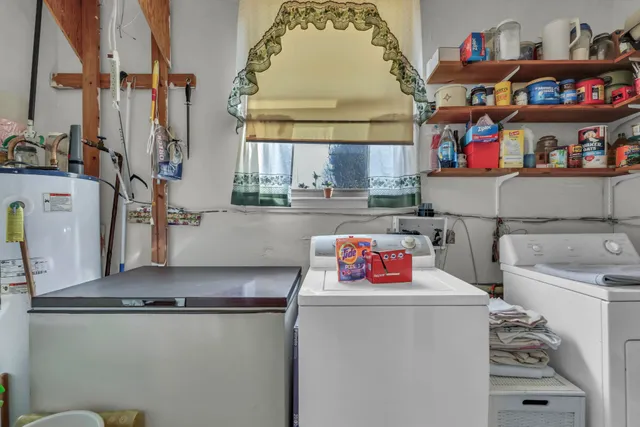 a utility room with dryer washer and a fridge