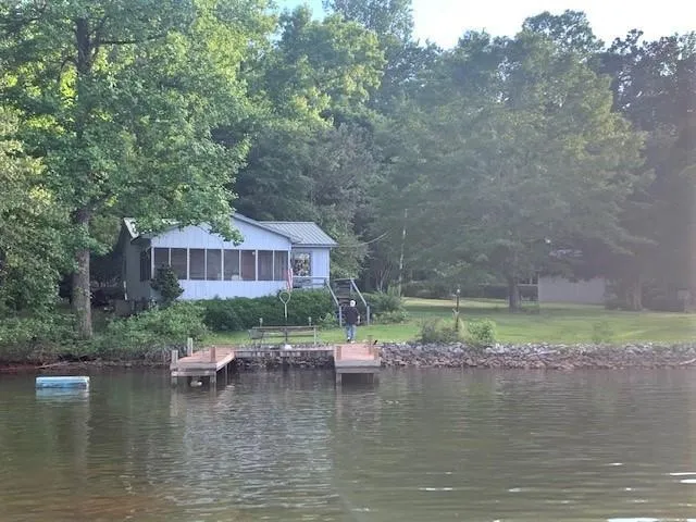 a view of swimming pool with a yard in the background