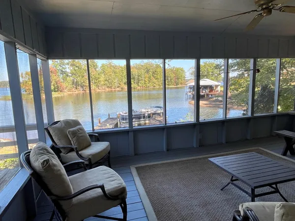 a living room with furniture and a floor to ceiling window