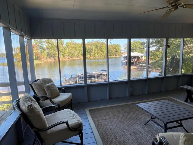 a living room with furniture and a floor to ceiling window