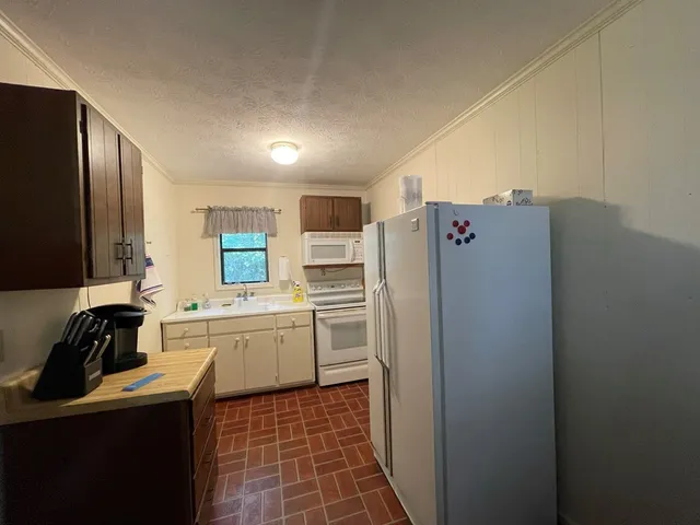a kitchen with a refrigerator and a sink