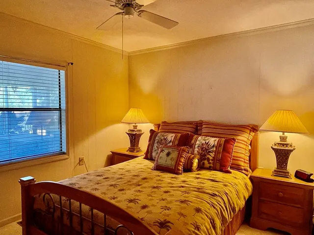 a bedroom with a bed and a night stand