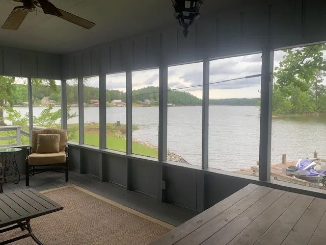 a living room with furniture and a floor to ceiling window