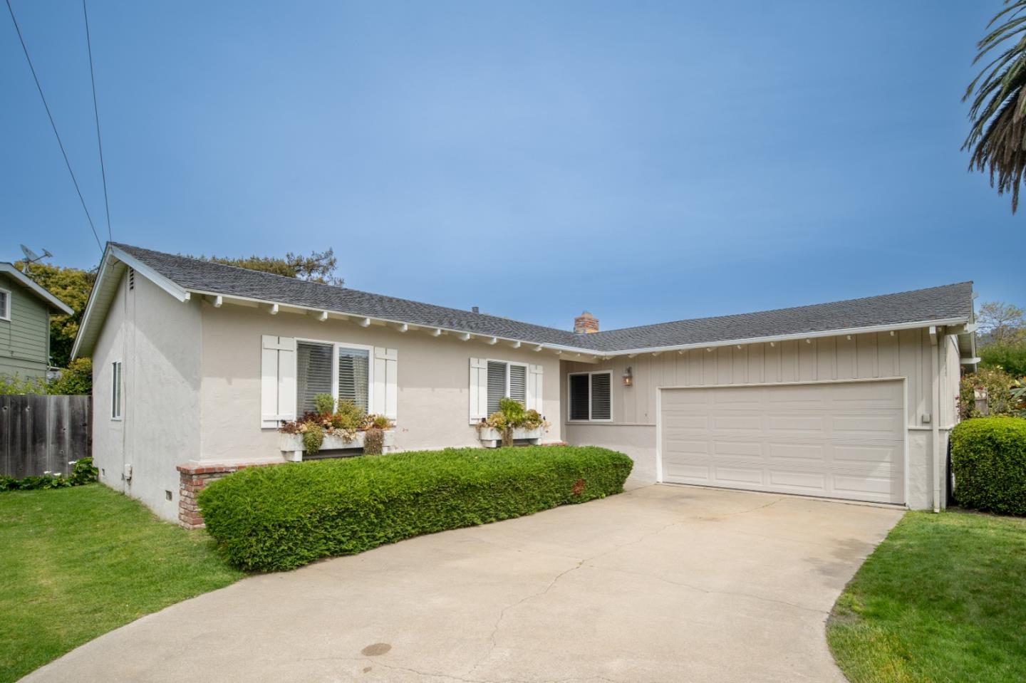 3445 Rio Road Carmel, CA 93923 - Photo 1 of 16 a front view of a house with a yard and garage