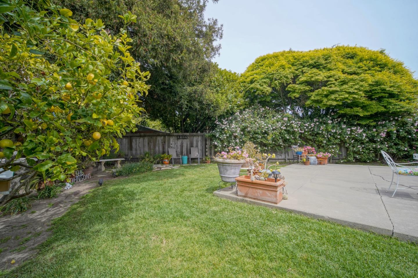 3445 Rio Road Carmel, CA 93923 - Photo 2 of 16 a backyard of a house with table and chairs