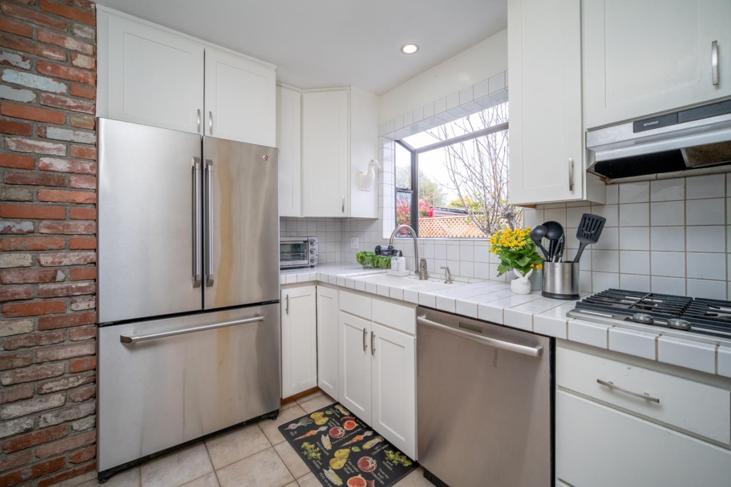 3445 Rio Road Carmel, CA 93923 - Photo 3 of 16 a kitchen with white cabinets and appliances