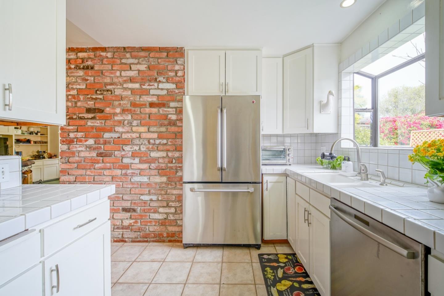 3445 Rio Road Carmel, CA 93923 - Photo 7 of 16 a kitchen with stainless steel appliances a refrigerator sink and cabinets