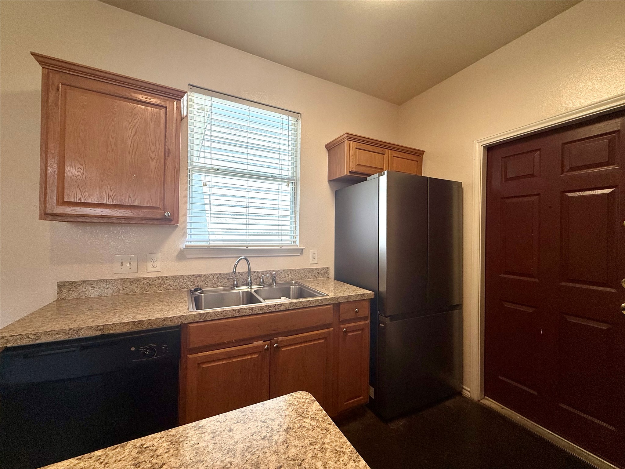 6912 Meador Avenue, Unit A Austin, TX 78752 - Photo 8 of 24 a kitchen with a sink and a refrigerator