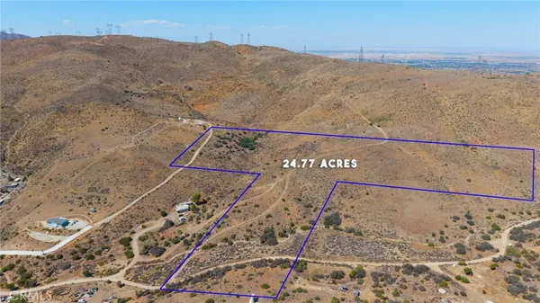 a view of a dry yard with mountain