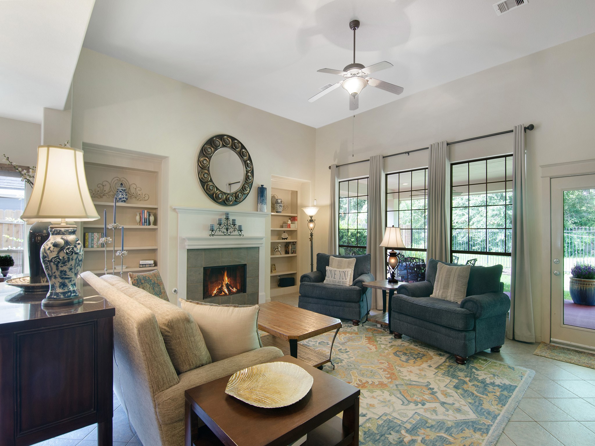 28323 Ryans Ridge Lane Spring, TX 77386 - Photo 23 of 45 Light-filled family room with soaring ceilings, built-in shelving, tile-surround fireplace overlooking backyard greenspace.
