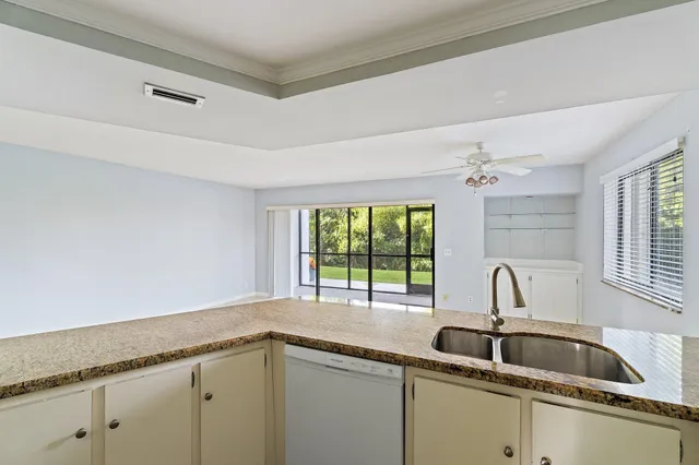 a kitchen with granite countertop a sink stove and refrigerator