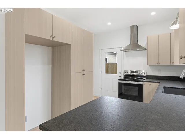 a kitchen with stainless steel appliances a refrigerator and stove