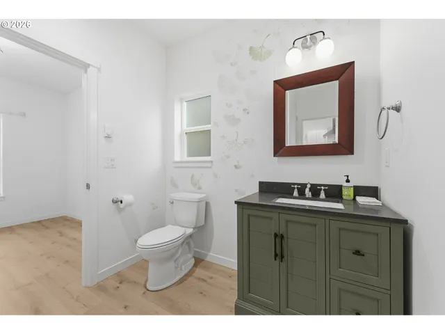 a bathroom with a toilet sink and mirror