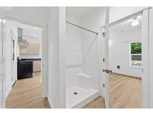 a bathroom with a glass shower door and a sink