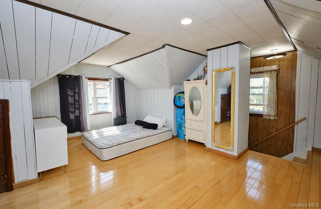 230-09 87th Avenue Queens, NY 11427 - Photo 12 of 22 a bedroom with a bed and window