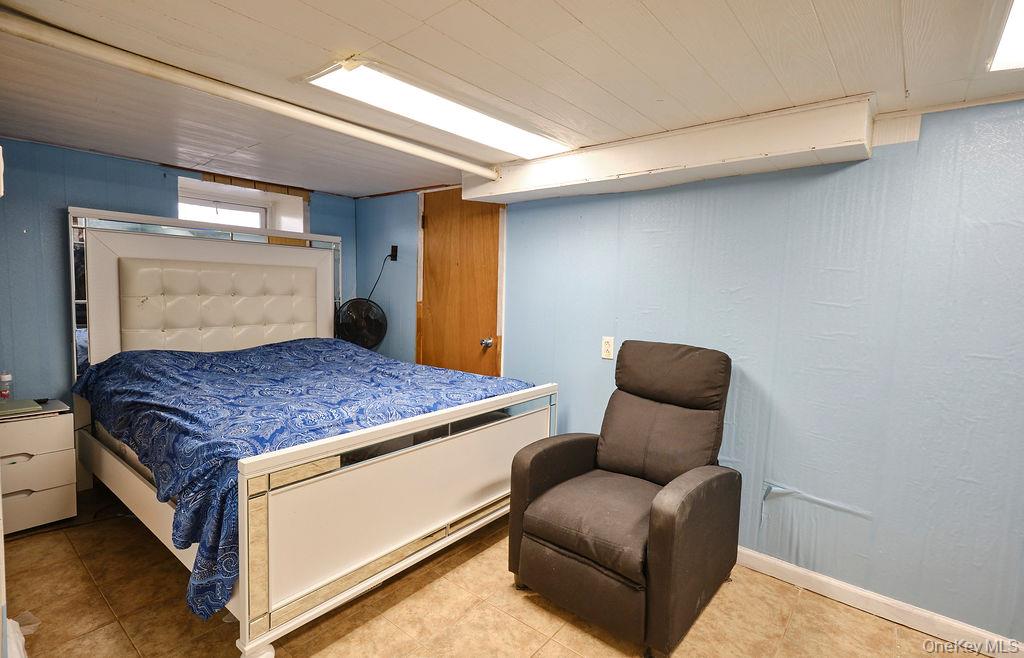 230-09 87th Avenue Queens, NY 11427 - Photo 14 of 22 a living room with furniture and a large window