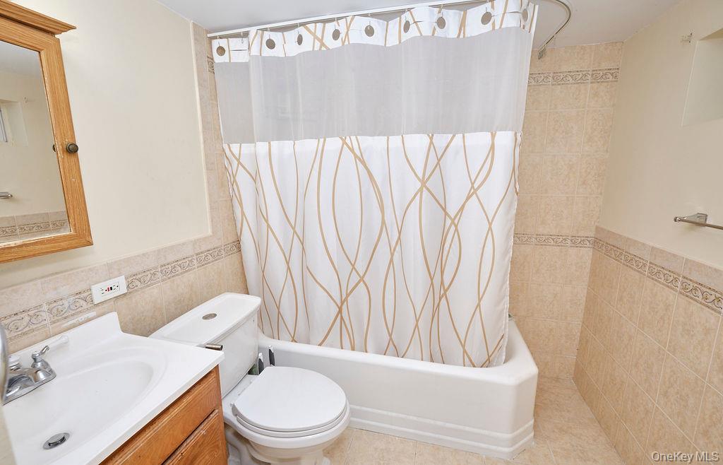 230-09 87th Avenue Queens, NY 11427 - Photo 15 of 22 a bathroom with a toilet and a sink