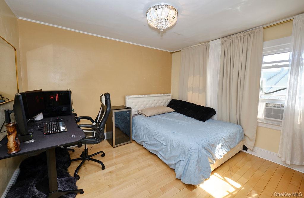 230-09 87th Avenue Queens, NY 11427 - Photo 8 of 22 a bedroom with a bed and a desk