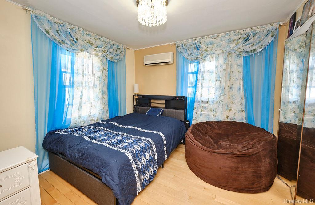 230-09 87th Avenue Queens, NY 11427 - Photo 9 of 22 a bedroom with a bed dresser and a window