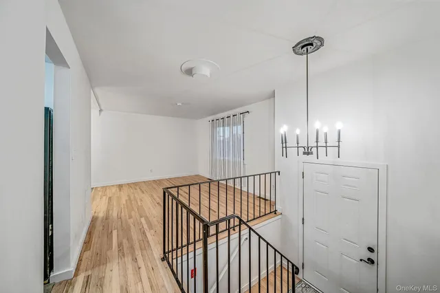 a view of hallway with wooden floor