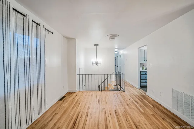 a view of hallway with wooden floor