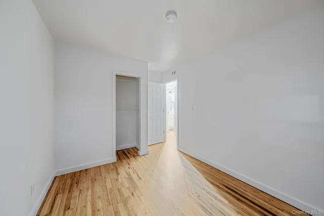 a view of room with window and wooden floor