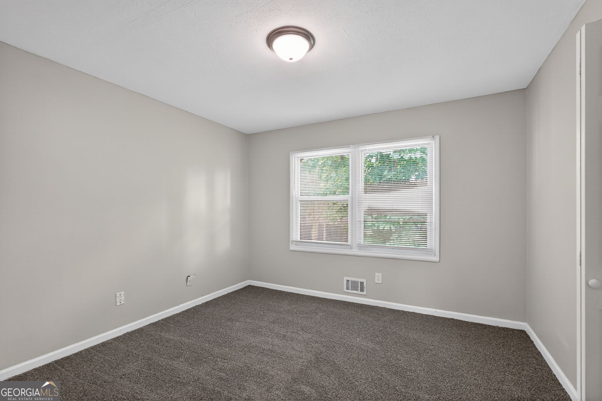 3285 Old Salem Road Southeast Conyers, GA 30013 - Photo 10 of 33 an empty room with a window