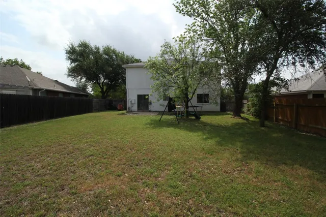 a view of a house with backyard and sitting area