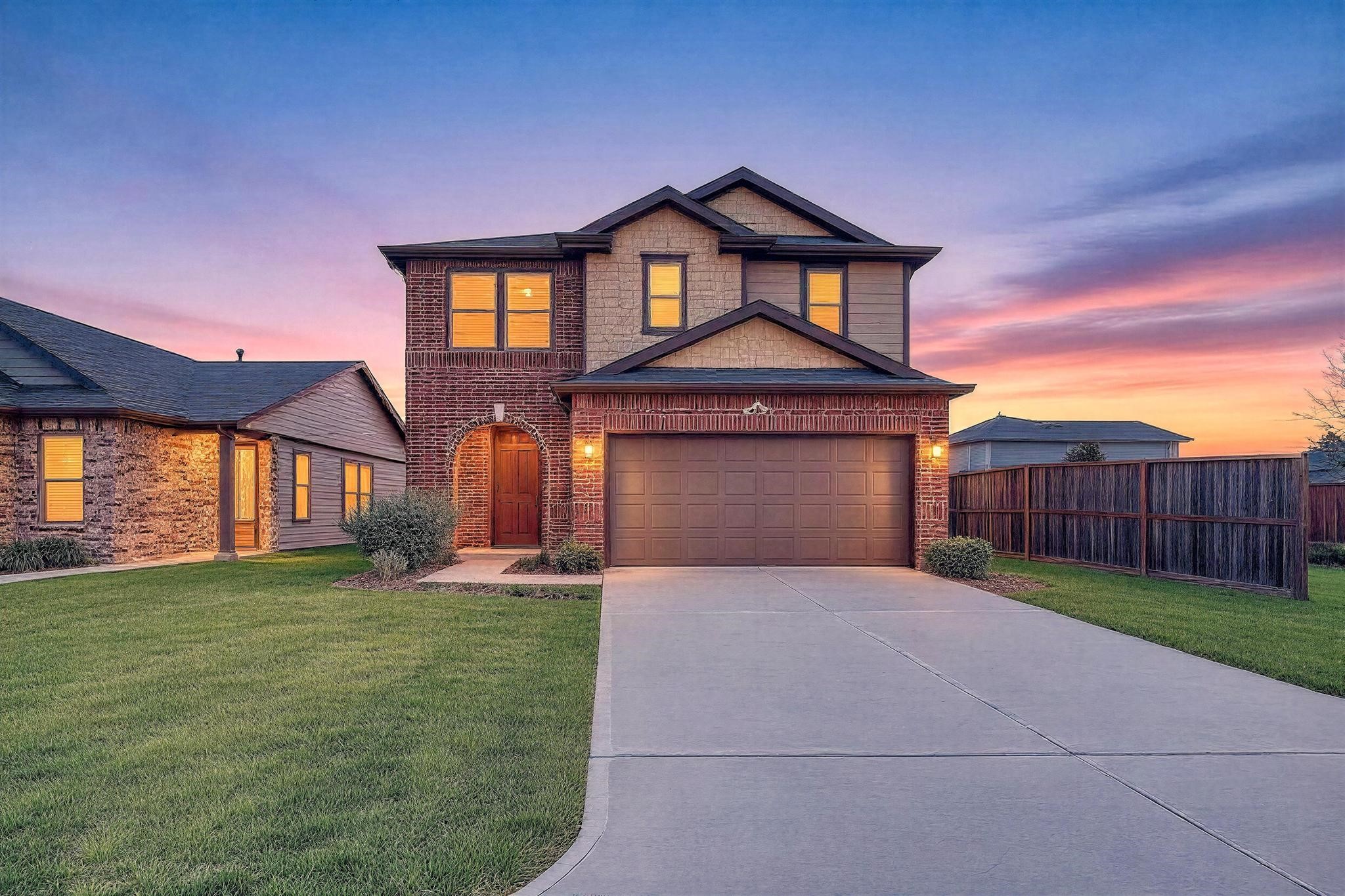 a front view of a house with a yard and garage
