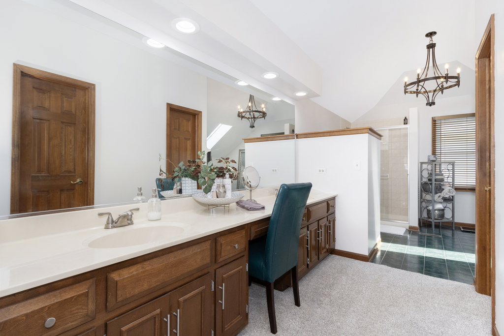 1712 Mundelein Road Naperville, IL 60565 - Photo 22 of 42 a spacious bathroom with a granite countertop sink a mirror and a bathtub