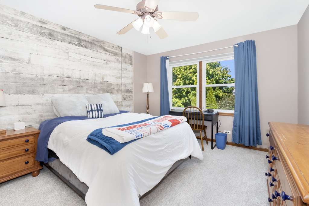 1712 Mundelein Road Naperville, IL 60565 - Photo 27 of 42 a bedroom with a bed and a table