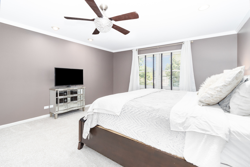 1712 Mundelein Road Naperville, IL 60565 - Photo 29 of 42 a bedroom with a bed tv and a window